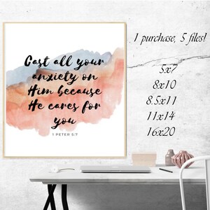 May include: A watercolor print with a quote from the Bible: "Cast all your anxiety on Him because He cares for you." The quote is in black text on a white background with a watercolor background in shades of pink, orange, and blue. The quote is from 1 Peter 5:7.