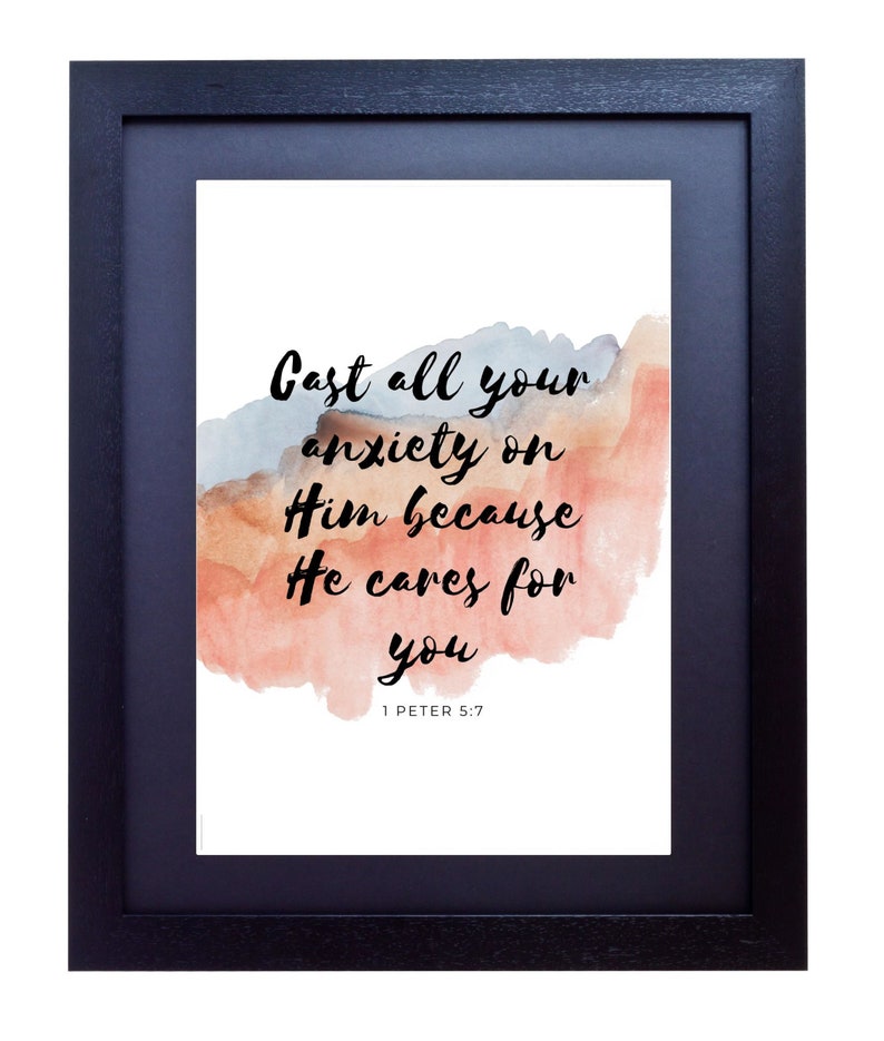 May include: A framed print with a watercolor background in shades of pink and blue. The print features a quote from the Bible, 1 Peter 5:7, which reads "Cast all your anxiety on Him because He cares for you."