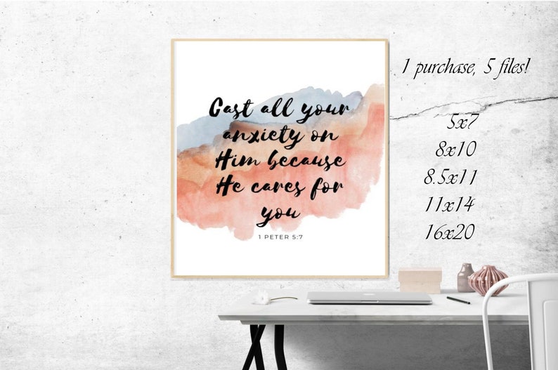 May include: A watercolor print with a quote from the Bible: "Cast all your anxiety on Him because He cares for you." The quote is in black text on a white background with a watercolor background in shades of pink, orange, and blue. The quote is from 1 Peter 5:7.