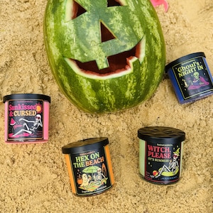 May include: A white ceramic mug with a black handle and the text "But First, Coffee" in a bold, black font. The mug is set against a blurred background, suggesting a cozy setting.