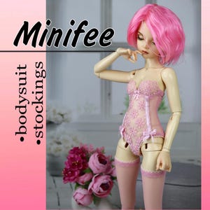 May include: A pink doll wearing a pink lace bodysuit and stockings. The doll has pink hair and is standing on a white surface. The text "Minifee" is written in black at the top of the image. The text ".bodysuit .stockings" is written in black on the left side of the image.