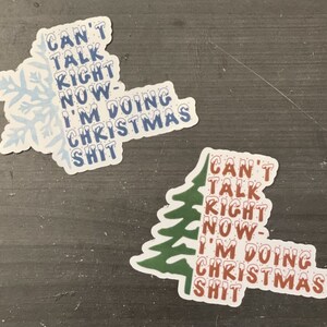 May include: Two Christmas-themed stickers featuring a snowflake and a pine tree. Both stickers display the text "Can't Talk Right Now - I'm Doing Christmas Shit."