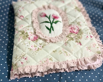 Vintage style, fiberfilled quilted stitched with floral pattern.Fully handmade bible or book cover with flower embroidery surrounded by lace