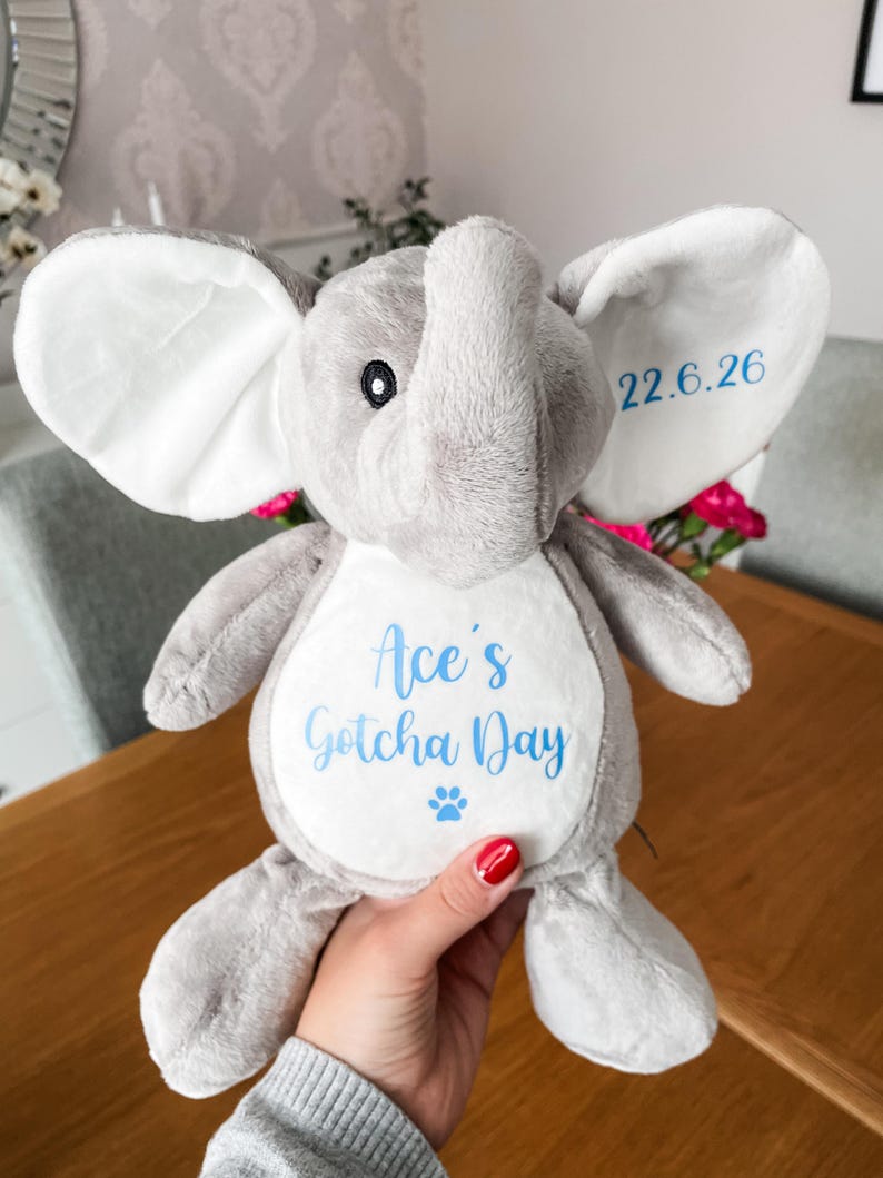 Plush personalised dog toy for gotcha day gift, being held to show the size, soft dog toy, custom gotcha day gift for a new puppy.