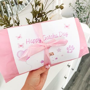 Personalised dog toy gift wrapping option, item wrapped in tissue paper with gift card and satin bow wrapped around to finish, instructions on how to add gift wrap at checkout, customisable gift wrap colours available, dog gotcha day gift.
