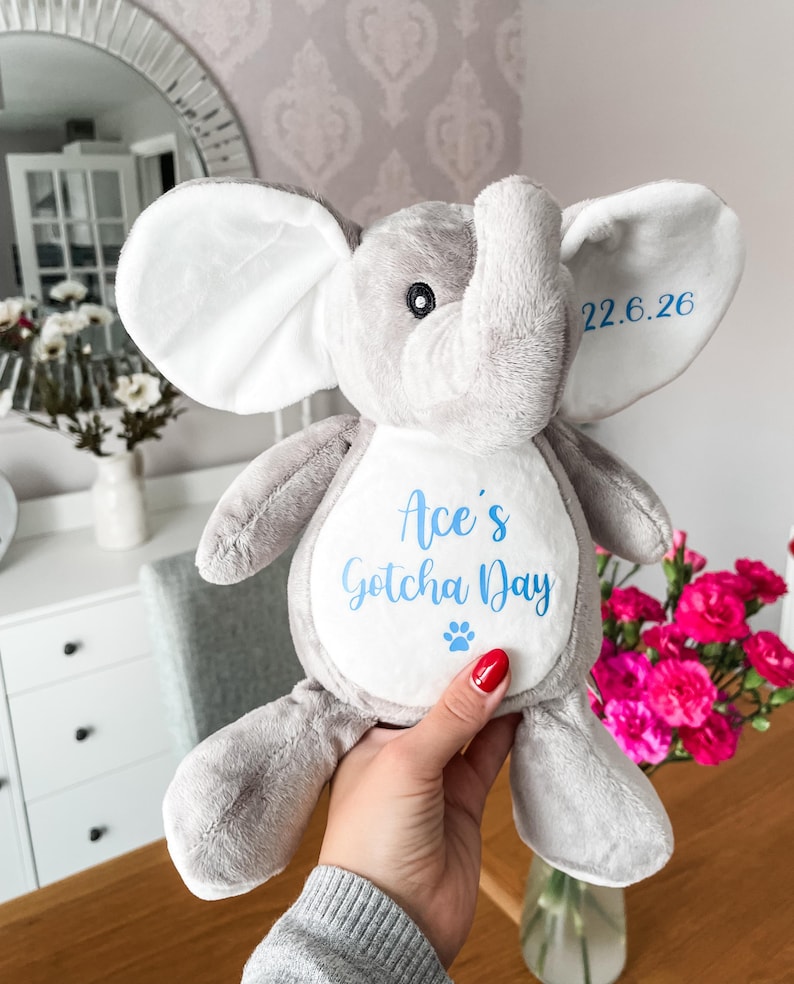 Plush personalised dog toy for gotcha day gift, being held to show the size, soft dog toy, custom gotcha day toy for dog elephant toy.