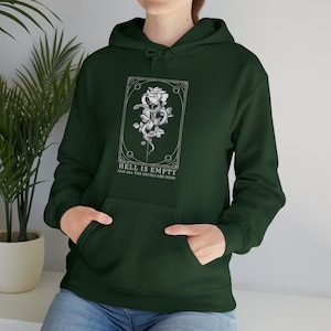 May include: A dark green hoodie with a white graphic print of a rose and snake with the text "Hell is empty and all the devils are here".