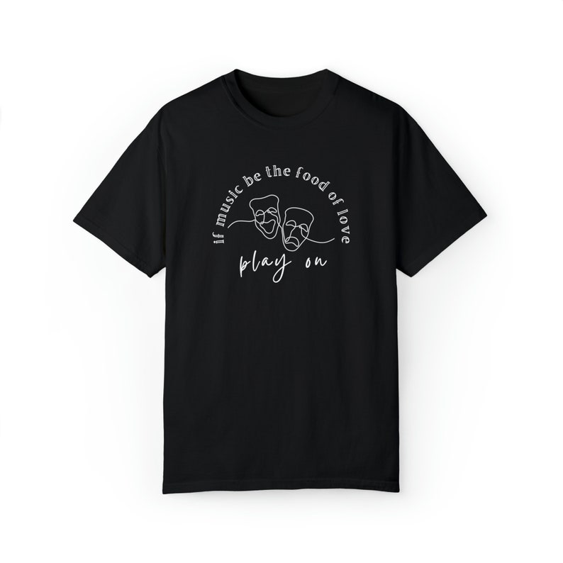May include: Black t-shirt with a white graphic design featuring two theatre masks and the text "If music be the food of love play on."