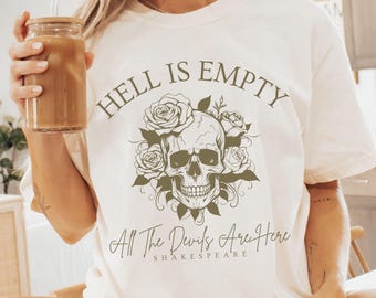 May include: White t-shirt with a skull and roses graphic and the text "Hell is Empty All The Devils Are Here Shakespeare".