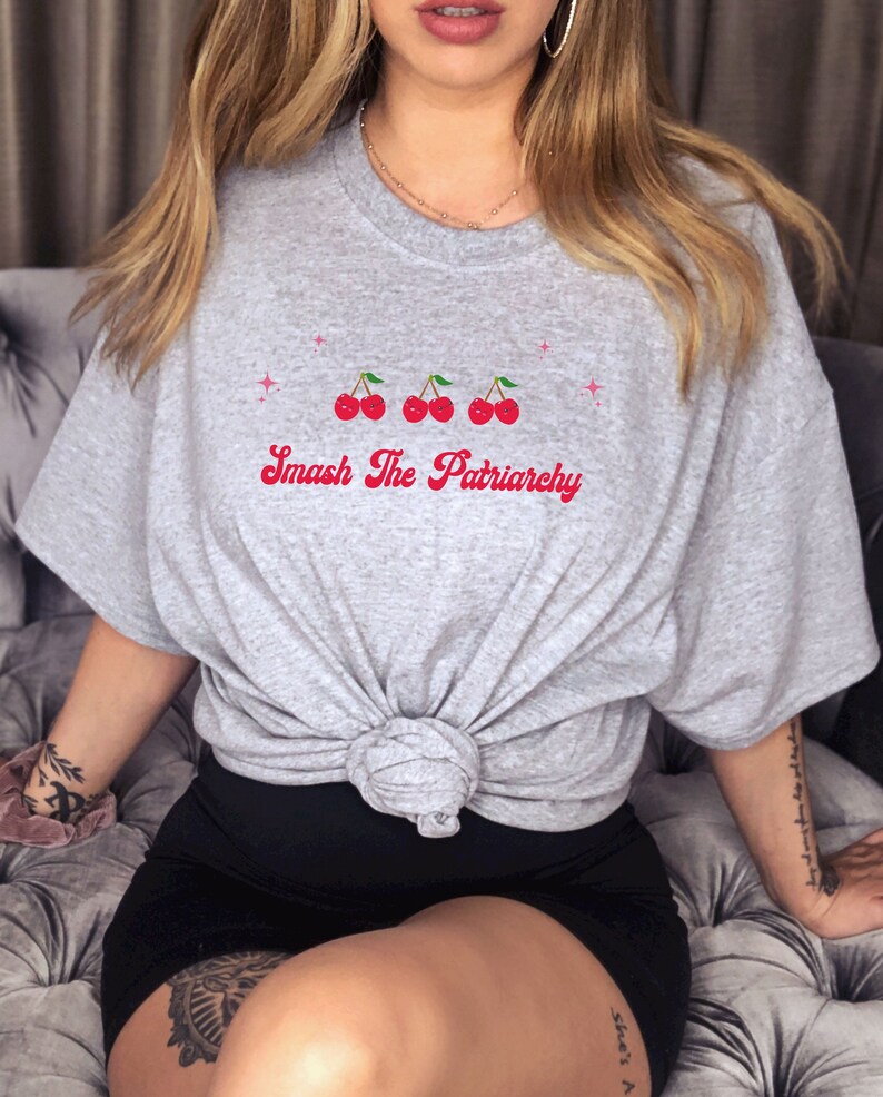 May include: Gray t-shirt with a graphic of three red cherries and the text "Smash The Patriarchy" in red.