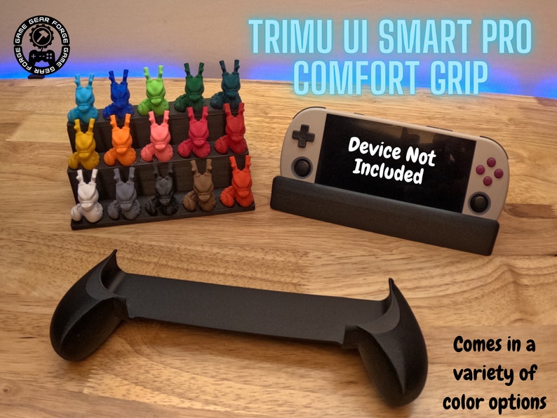 K&ouml;nnte beinhalten: Ein schwarzer 3D-gedruckter Griff f&uuml;r eine Nintendo Switch-Konsole. Der Griff hat zwei Handgriffe und eine flache Basis, um die Konsole zu halten. Der Text "TRIMU UI SMART PRO COMFORT GRIP" wird &uuml;ber dem Griff angezeigt. Der Text "Device Not Included" wird auf dem Bildschirm der Konsole angezeigt. Der Griff ist in verschiedenen Farben erh&auml;ltlich.
