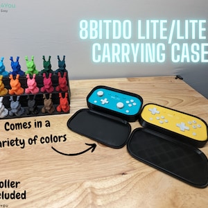 May include: A black carrying case for the 8BitDo Lite and Lite 2 controllers. The case is open and the controllers are not included. The case is made of hard plastic and has a smooth finish. The case is designed to protect the controllers from damage. The case is available in a variety of colours.