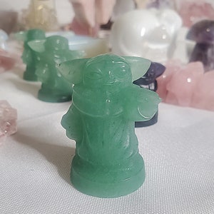 May include: A green, hand-painted, ceramic figurine of a popular fictional character. The figurine is detailed with facial features and a robe-like garment.
