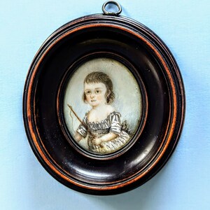 A portrait miniature of a young boy with a whip by William Read, circa 1795.