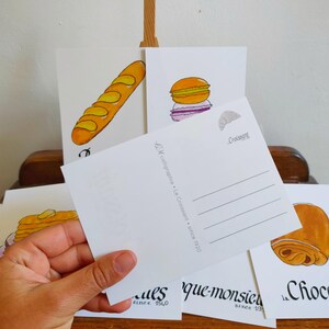 Carte postale : Baguette | Croissant | Chocolatine | Croissant | Crêpe | Macaron | Café | Chouquette | Croque-Monsieur image 2