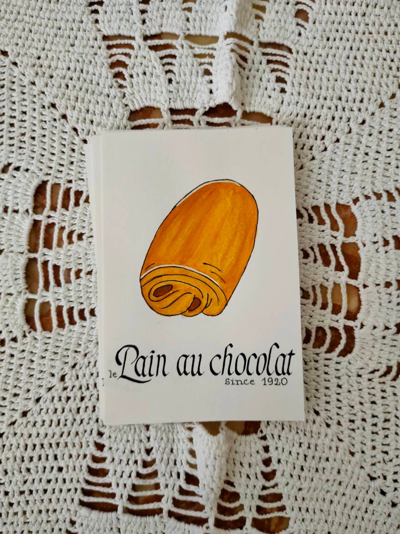 Carte postale : Baguette | Croissant | Chocolatine | Croissant | Crêpe | Macaron | Café | Chouquette | Croque-Monsieur Pain au chocolat