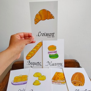 Carte postale : Baguette | Croissant | Chocolatine | Croissant | Crêpe | Macaron | Café | Chouquette | Croque-Monsieur