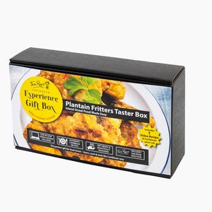 May include: A black box with a colourful label featuring a plate of plantain fritters. The label reads "Experience Gift Box" and "Plantain Fritters Taster Box". The box includes a video recipe and Caribbean spice rub.