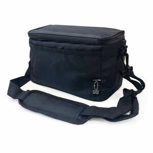 May include: Black insulated lunch bag with a shoulder strap and a top handle. The bag has a rectangular shape with a zippered closure. The bag has a small white tag with a bottle graphic. The bag is made of recycled plastic.