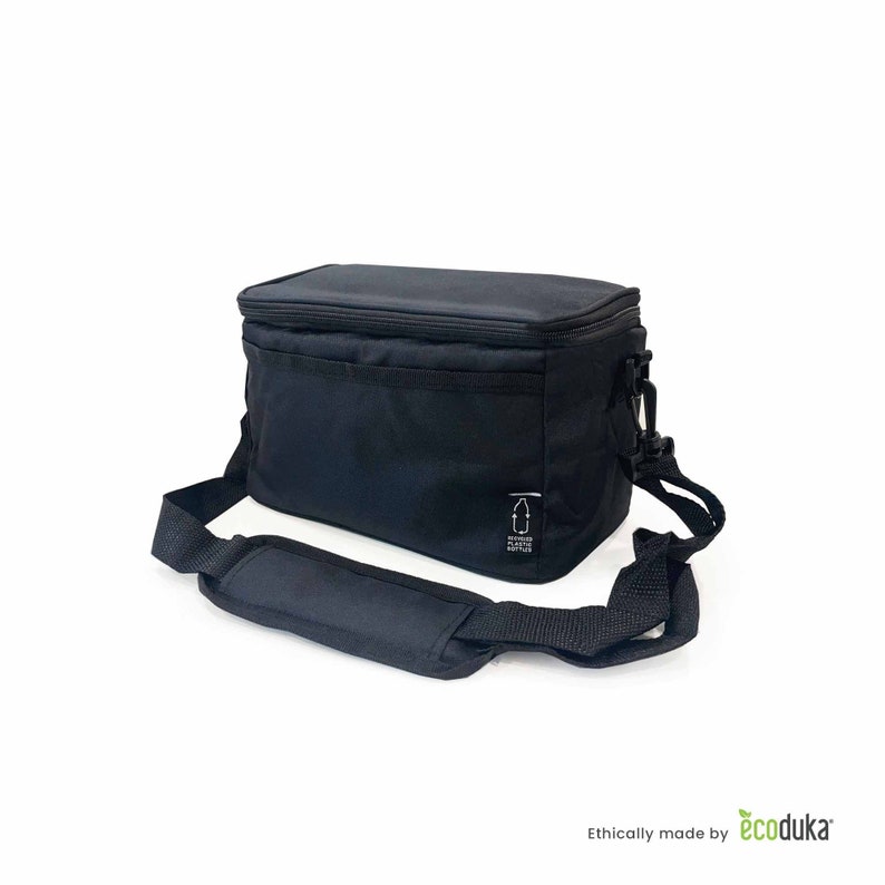 May include: Black insulated lunch bag with a shoulder strap and a top handle. The bag has a rectangular shape with a zippered closure. The bag has a small white tag with a bottle graphic. The bag is made of recycled plastic.