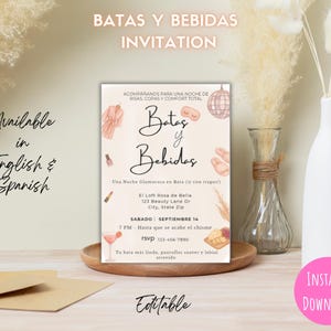 May include: A light beige invitation with the text "BATAS Y BEBIDAS INVITATION" at the top. The invitation includes the text "Available in English & Spanish" and "INSTANT DOWNLOAD". The invitation has illustrations of a robe, slippers, and a cocktail.