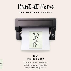 May include: A black printer is shown with a printed paper coming out. The paper has the text "Dela Mora Creates" in a script font. The text "Print at Home" and "Get Instant Access" are at the top. The text "No Printer?" and instructions are at the bottom.