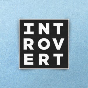 May include: Black and white square sticker with the word "INTROVERT" written in white letters.
