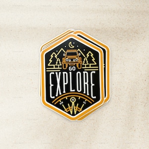 May include: A black and yellow sticker with a compass, a jeep, and the text "GO EXPLORE".