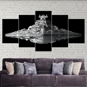 May include: A black and white image of a Star Destroyer spaceship against a black background. The spaceship is a large, rectangular vessel with a long, thin bridge and a large, round engine.