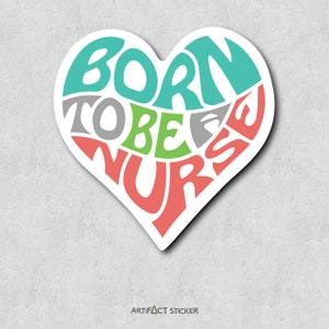 May include: A heart-shaped sticker with the text "Born to be a Nurse" in a colorful, stylized font. The words are arranged in a circular pattern within the heart shape. The sticker is white with a red, green, gray, and blue color scheme.