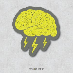 May include: A gray sticker with a yellow brain illustration and three yellow lightning bolts. The sticker has the text "ARTIFACT STICKER" at the bottom.