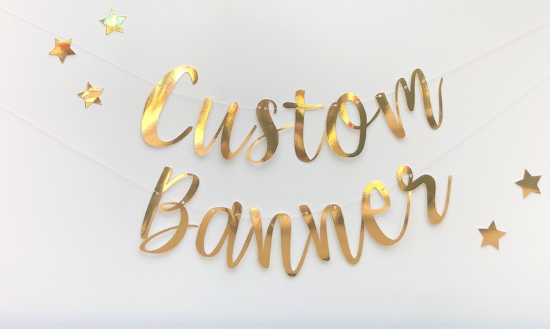 May include: Gold foil banner with the words "Custom Banner" and gold foil stars.