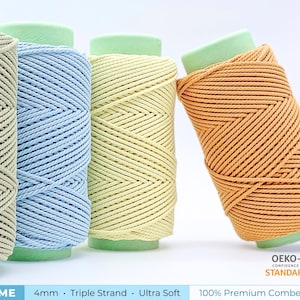 May include: A collection of colorful spools of 4mm triple strand cotton cord. The spools are in shades of beige, light blue, yellow, and orange. The text "SUPREME" and "100% Premium Combed Cotton" are visible.