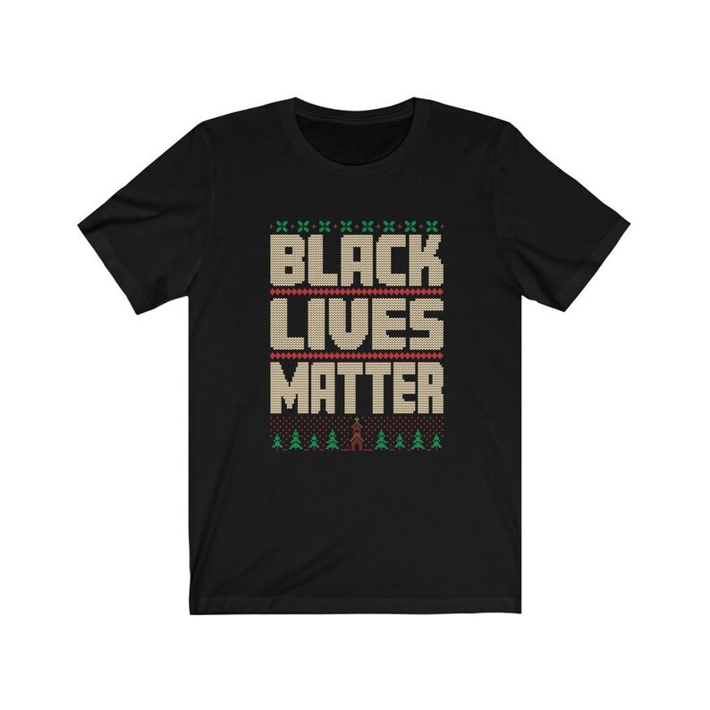 May include: Black T-shirt with a Christmas sweater design featuring the words "Black Lives Matter" in a beige knit font with green and red accents.