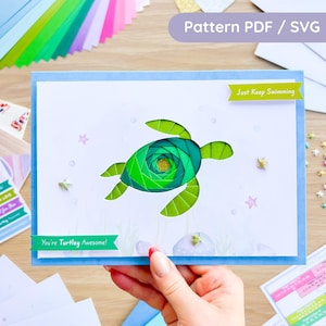 May include: A handmade greeting card featuring a layered green sea turtle design. The card has a blue border and includes the phrases "Just Keep Swimming" and "You're Turtley Awesome!" along with star and bubble embellishments. The words "Pattern PDF / SVG" are also visible.