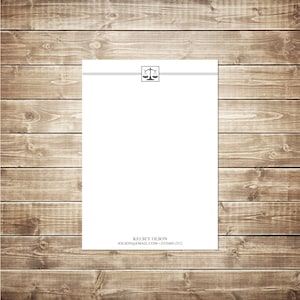 May include: A white letterhead with a black scale of justice icon and a black line above it. The text at the bottom reads "Kelsey Olson, kolson@email.com, (925)489-2312".