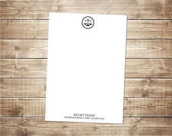 May include: White notepad with a black scale of justice icon and the text "Kelsey Olson, jolson@email.com, +925489-2212" at the bottom.