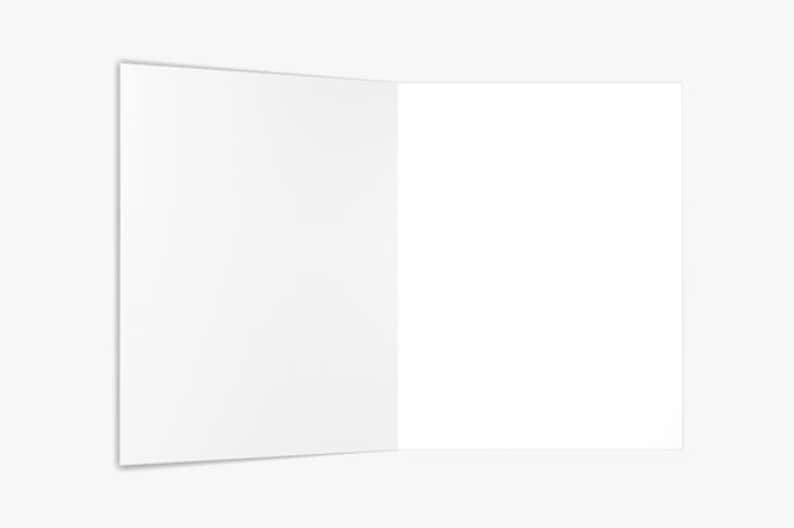 May include: A blank white card folded in half, with the inside of the card facing the viewer.