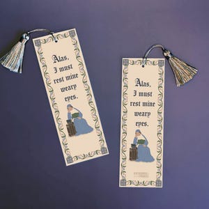 May include: Two rectangular bookmarks with silver tassels. Each bookmark has the text "Alas, I must rest mine weary eyes." A woman in a blue dress is illustrated on each bookmark. The bookmarks have a decorative border.