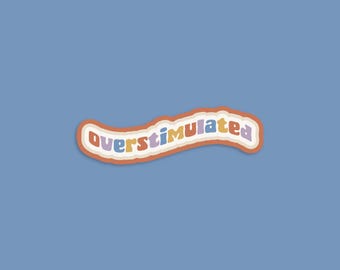 May include: A sticker with the text "overstimulated" in a wavy, colorful font. The sticker is orange, yellow, purple, and blue.