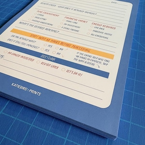 May include: A blue notepad with the text "THIS CHANGES EVERYTHING" at the top. The notepad has sections for idea/question, reality check, time commitment, financial impact, and energy required. The notepad also has the text "STOP! WAIT 48 HOURS BEFORE PROCEEDING".
