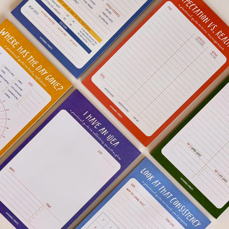 May include: A collection of colorful, rectangular notepads with various prompts and titles. The pads feature titles like "Where Has The Day Gone?" and "I Have An Idea." Each pad has a different color border, including blue, orange, red, purple, and green.