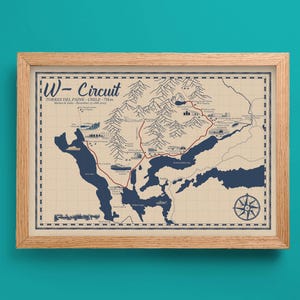 May include: Framed map print of the W-Circuit in Torres del Paine, Chile. The map features a detailed illustration of the hiking trail with blue lakes, mountains, and a compass rose. The print is in a wooden frame.