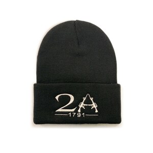 May include: Black knit beanie with a white embroidered logo that says "2A - 1791" with two crossed rifles.