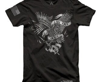 May include: Black t-shirt featuring a graphic of a bald eagle holding a flag with the text "Live Free or Die".