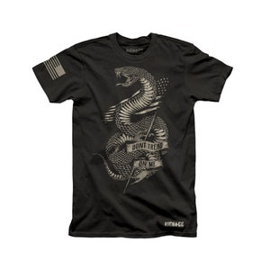 May include: Black t-shirt featuring a graphic of a snake wrapped around a spear with the text "Don't Tread On Me". The snake is in a vintage style and the text is in a banner.