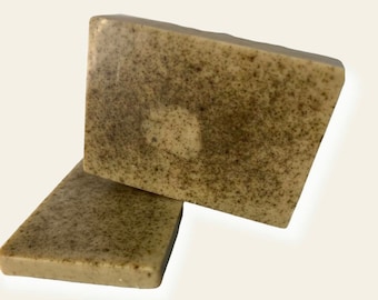 May include: Two bars of handmade soap with a speckled brown and white appearance. The soap is made with natural ingredients and is perfect for sensitive skin.