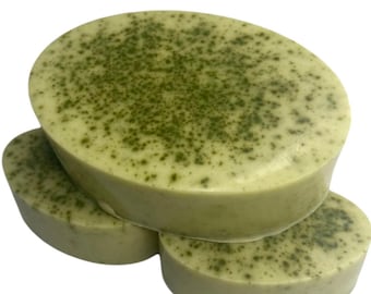 May include: Three oval-shaped bars of green and white soap. The soap has a speckled appearance with green flecks throughout.