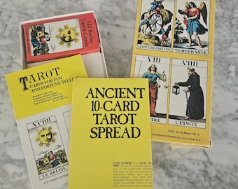 May include: A collection of vintage tarot cards and guidebooks. The image shows several decks of cards, including one labeled "1JJ Swiss Tarot Cards." Guidebooks with titles like "Tarot Cards for Fun and Fortune Telling" and "Ancient 10-Card Tarot Spread" are also visible.