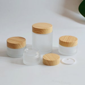 5g 15g 30g 50g 100g Barattolo per crema Contenitore per olio essenziale Crema per il viso Cura della pelle Imballaggio cosmetico Tappo effetto legno Vetro smerigliato All'ingrosso